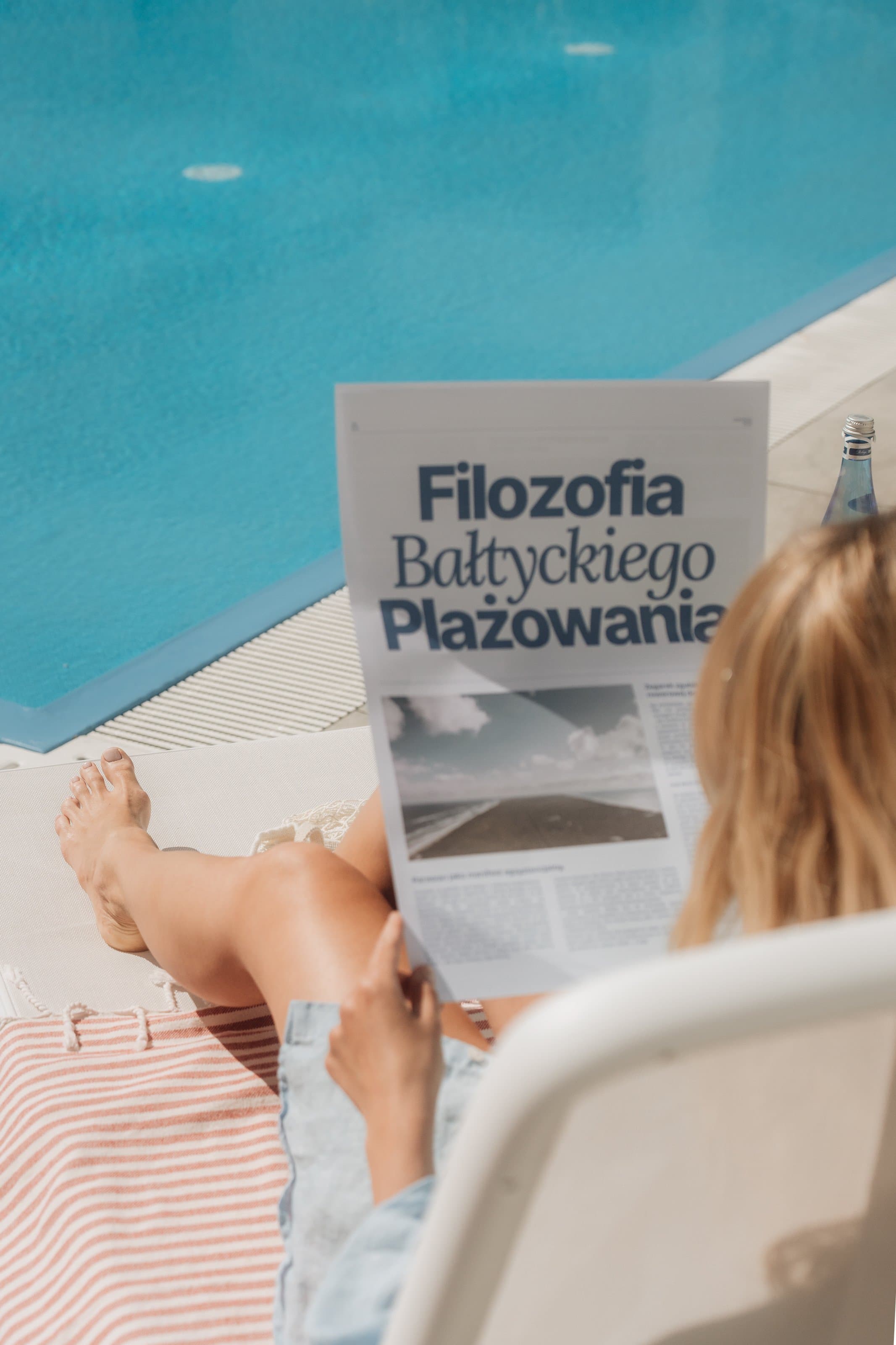 Reading newspaper by the pool